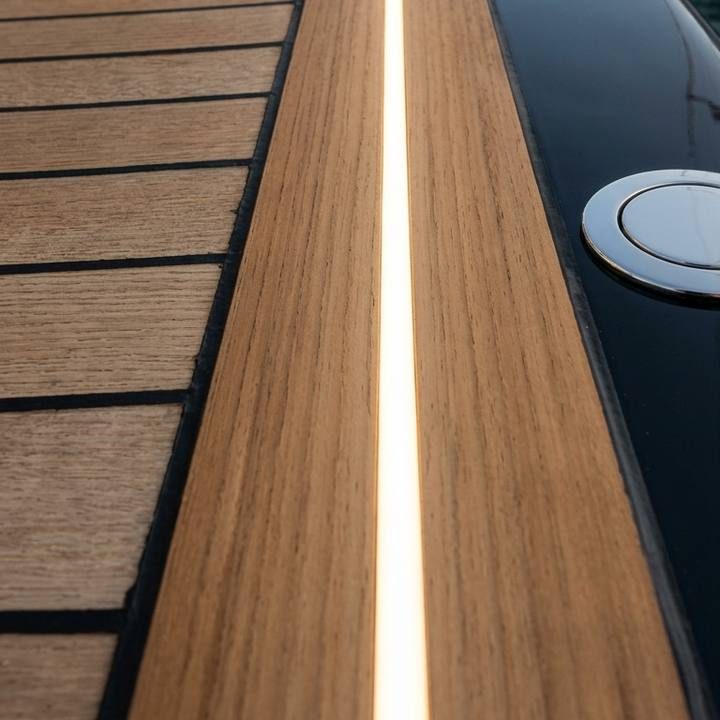 Flush LED lighting integrated between solid teak planks