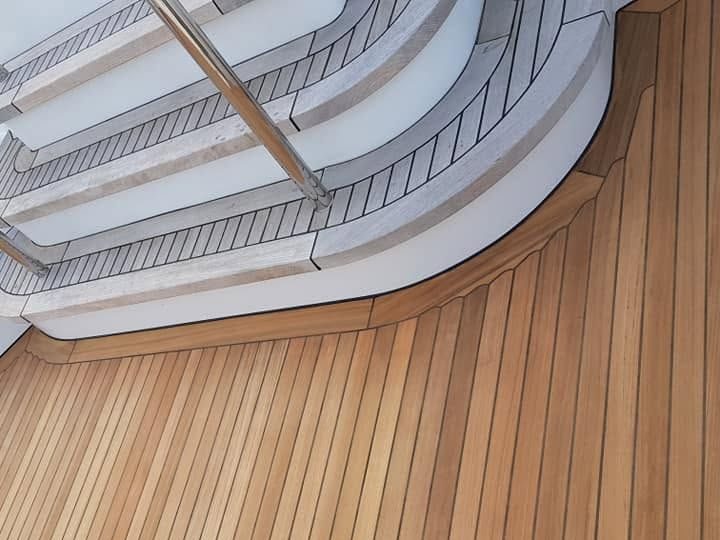 Curved teak deck and stairway after restoration
