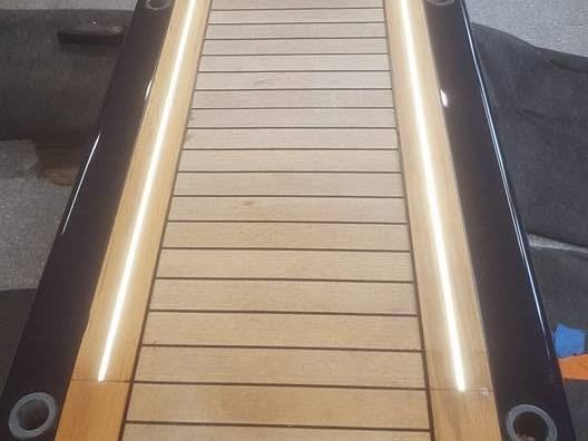 Teak passerelle with integrated LED lighting at night